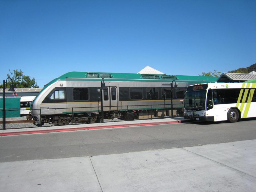 A SMART train passes a Marin Transit bus at the San Rafael Transit Center on Tuesday, July 13, 2021.