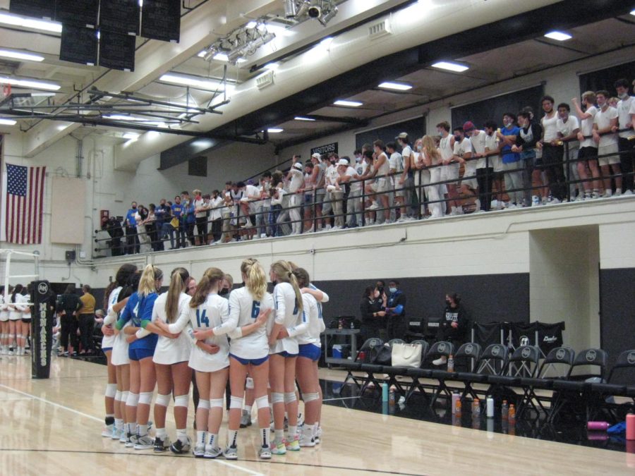 The team huddles during the third set as the Branson audience looks on, Nov. 10, 2021.