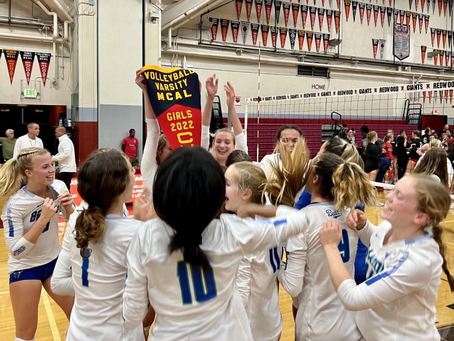 Girls varsity volleyball celebrates its MCAL pennant after winning the league final against Redwood, Oct. 21, 2022. Branson avenged an earlier loss to claim the title in three sets.