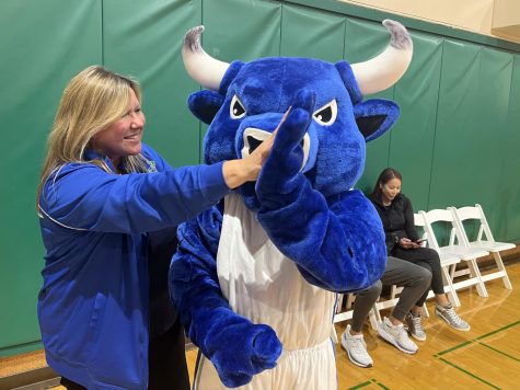 Frances Dillon high-fives the brand-new bull mascot in October. She assumed the interim athletics director post this year.