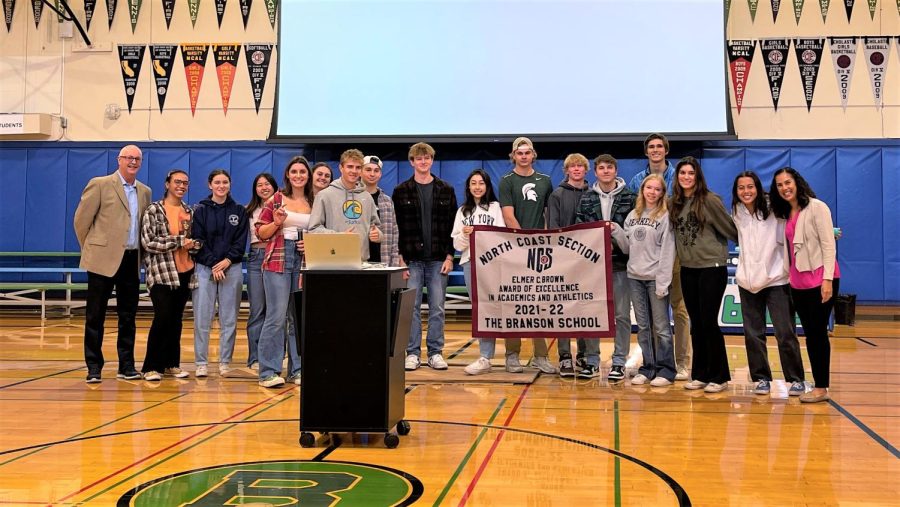 Students hold the Elmer C. Brown banner, Oct. 11, 2022. The North Coast Section award recognized Branson’s academic and athletic strength.