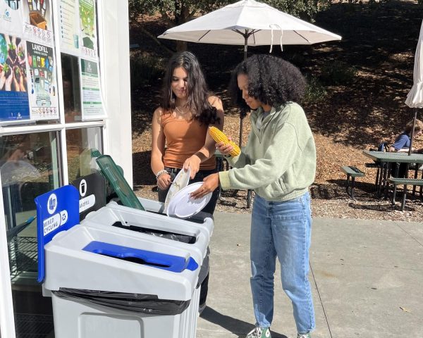 Students empty their compost scraps into new sorting bins in front of the commons. The compost sorting system was implemented at the beginning of the 2023-24 school year.