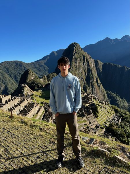 Alexander Golden '24 stands at Machu Picchu as part of his ethnographic study on Peru. His research is part of the Chase Junior Fellowship he was awarded. Courtesy of Alexander Golden