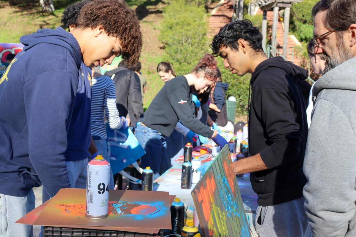 Students participate in the spray painting workshop during the Beloved Community event on Jan. 11.