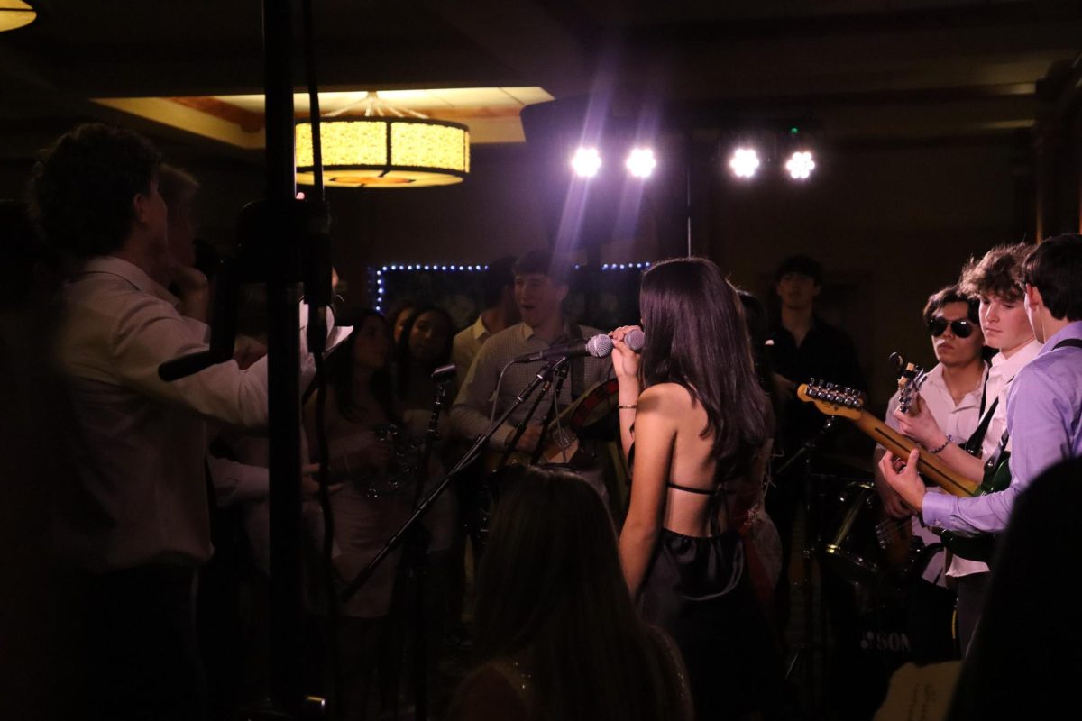 Sophia Duran 25 sings on the microphone at winter formal. Duran and Rock Band are favorites among the Branson community at events like this.