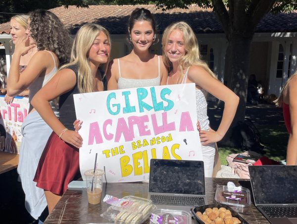 The girls a capella club, the Branson Bellas, holds up their sign at the clubs fair. The Sept. 12 fair featured a variety and record-high number of Branson clubs.