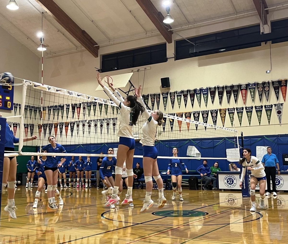 Ella Tsai '26 and Ellie Corsello '26 jump for a block during Branson's 3-0 game against Foothill. 