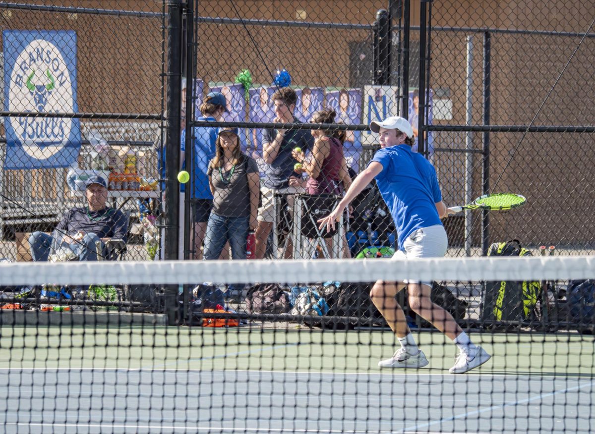 Finn Higgins '27 plays singles match against MC. The Bulls moved on to play Redwood in the finals.