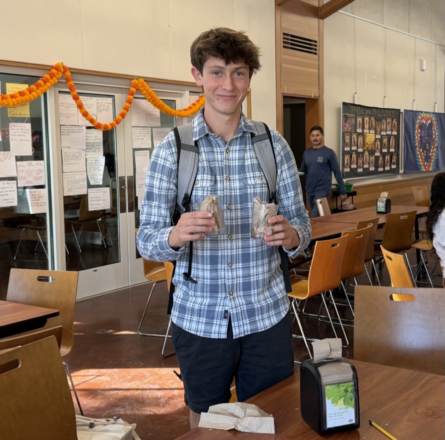 Zander Alpert '26 helps clean up tables in the Commons.