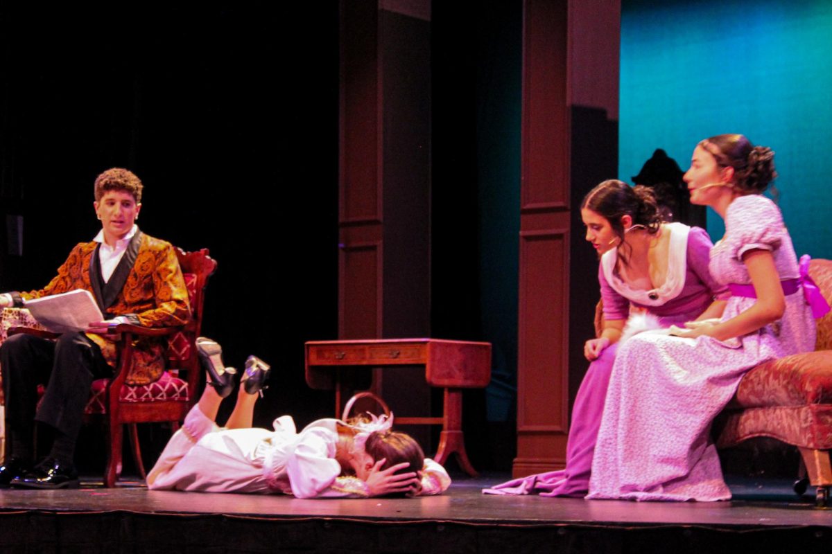 Actors wear costumes designed by London Mullarkey.