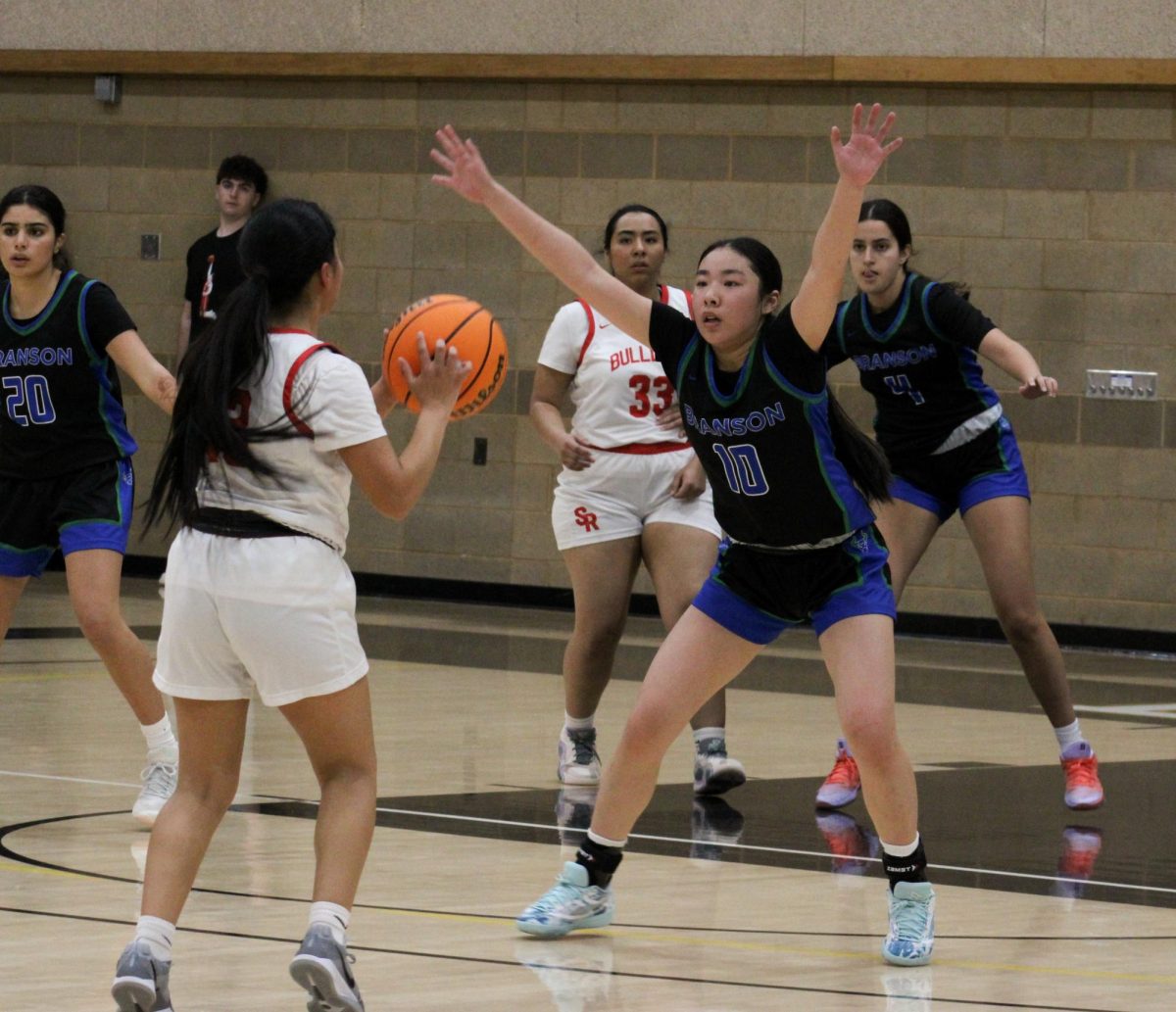 Alyssa Huang '28 blocks a shot